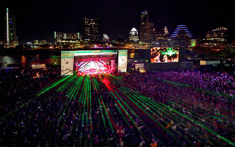 SXSW music festival stage with vibrant lighting and crowd enjoying performances